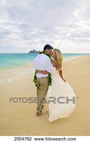 Stock Image - Hawaii, Oahu, Kailua, Lanikai Beach, Attractive Newlyweds On Beach, View From Behind.. Fotosearch