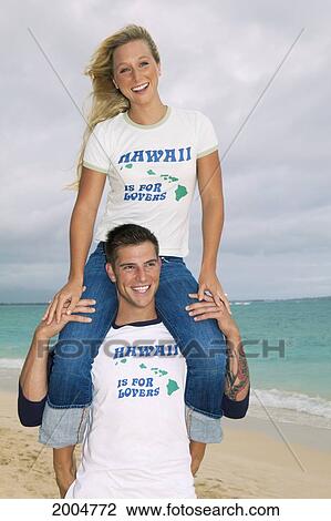 Stock Image - Hawaii, Oahu, Kailua, Lanikai Beach, Attractive Newlywed Couple On Beach.. Fotosearch