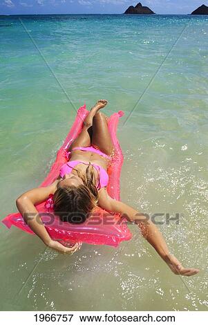 Stock Photo - Hawaii, Oahu, Kailua, Lanikai Beach, Teenage Girl In Ocean On Inflatable.. Fotosearch