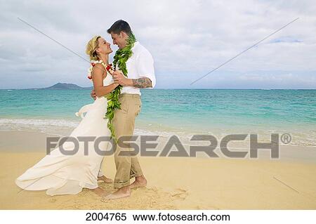 Stock Photography - Hawaii, Oahu, Kailua, Lanikai Beach, Attractive Newlywed Couple Dancing On Beach.. Fotosearch