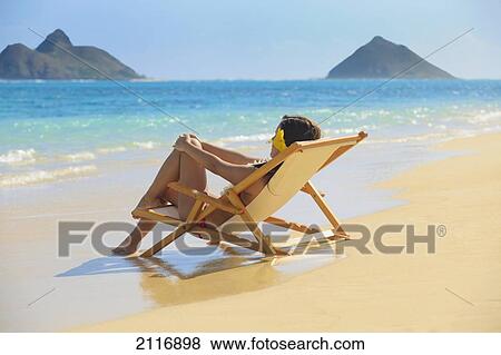 Hawaii, Oahu, Kailua, Lanikai, Beautiful woman lounges on a remote beach. View Large Photo Image Stock Photo - Hawaii, Oahu, Kailua, Lanikai, Beautiful woman lounges on a remote beach.. Fotosearch