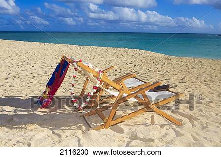 Stock Image - Hawaii, Oahu, Kailua, Two lounge chairs on the white sandy beach of Lanikai.. Fotosearch