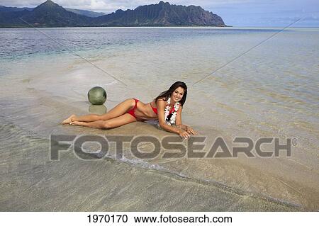 Stock Image - Hawaii, Oahu, Kaneohe Bay, Beautiful Woman Laying On The Sandbar. Fotosearch
