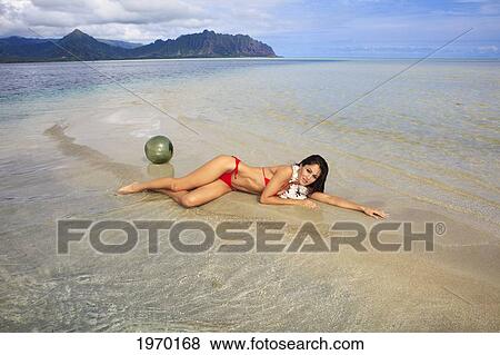 Stock Photo - Hawaii, Oahu, Kaneohe Bay, Beautiful Woman Laying On The Sandbar. Fotosearch