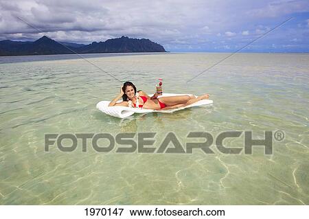 Hawaii, Oahu, Kaneohe Bay, Woman Floating On A Raft With A Tropical Drink View Large Photo Image Stock Photo - Hawaii, Oahu, Kaneohe Bay, Woman Floating On A Raft With A Tropical Drink. Fotosearch
