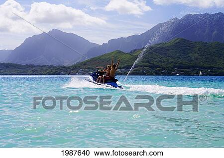 Hawaii, Oahu, Kaneohe, Young People Riding Jetski Out To The Sandbar Or Dissapearing Island View Large Photo Image Stock Image - Hawaii, Oahu, Kaneohe, Young People Riding Jetski Out To The Sandbar Or Dissapearing Island. Fotosearch