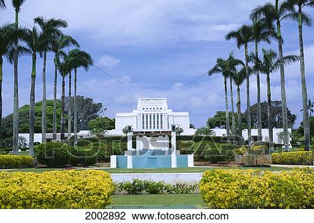 Stock Image - Hawaii, Oahu, Laie, Front View Of Mormon Temple, Manicured Grounds, Palms, Blue Sky. Fotosearch
