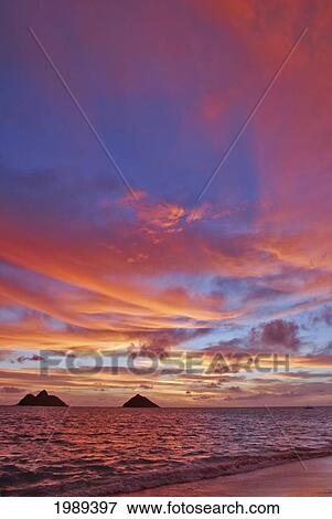 Stock Photo - Hawaii, Oahu, Lanikai, A Colorful Pink Sunrise Over The Mokulua Islands.. Fotosearch