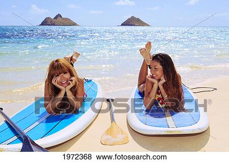 Hawaii, Oahu, Lanikai, Asian Women Paddle Boarding Off The Beach Near Mokulua Island. View Large Photo Image Stock Photo - Hawaii, Oahu, Lanikai, Asian Women Paddle Boarding Off The Beach Near Mokulua Island.. Fotosearch