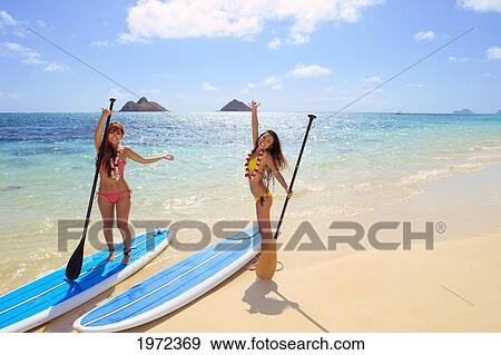 Hawaii, Oahu, Lanikai, Asian Women Paddle Boarding Off The Beach Near Mokulua Island. View Large Photo Image Stock Photo - Hawaii, Oahu, Lanikai, Asian Women Paddle Boarding Off The Beach Near Mokulua Island.. Fotosearch