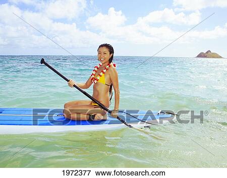 Hawaii, Oahu, Lanikai, Asian Women Paddle Boarding Off The Beach Near Mokulua Island. View Large Photo Image Stock Photo - Hawaii, Oahu, Lanikai, Asian Women Paddle Boarding Off The Beach Near Mokulua Island.. Fotosearch