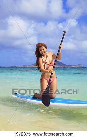 Stock Photography - Hawaii, Oahu, Lanikai, Asian Women Paddle Boarding Off The Beach Near Mokulua Island.. Fotosearch
