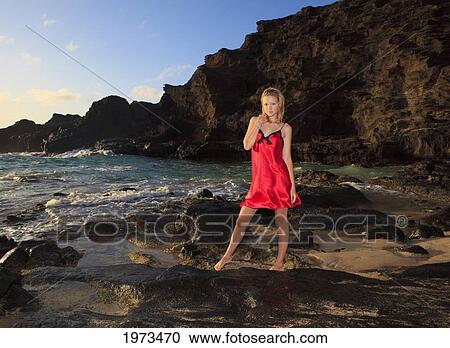 Hawaii, Oahu, Lanikai, Attractive Girl In The Beautiful Sunset Light At The Beach Standing On Rocks. View Large Photo Image Stock Image - Hawaii, Oahu, Lanikai, Attractive Girl In The Beautiful Sunset Light At The Beach Standing On Rocks.. Fotosearch