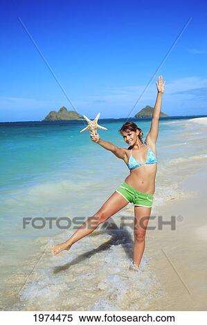 Stock Photography - Hawaii, Oahu, Lanikai, Attractive Young Woman On The Beach.. Fotosearch