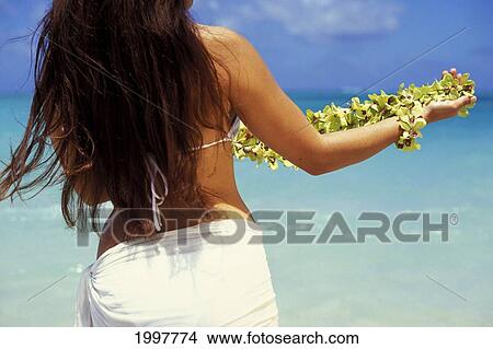 Hawaii, Oahu, Lanikai, Back Of Local Woman, Lei Wrapped On Arm, Standing Facing Ocean. View Large Photo Image Picture - Hawaii, Oahu, Lanikai, Back Of Local Woman, Lei Wrapped On Arm, Standing Facing Ocean.. Fotosearch