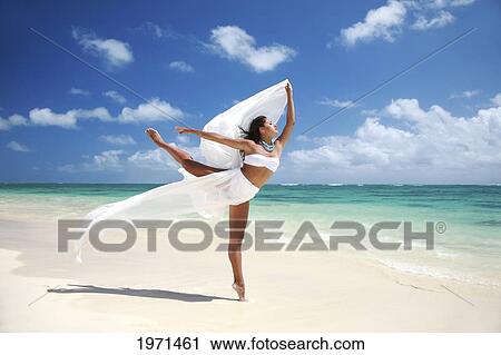 Stock Image - Hawaii, Oahu, Lanikai Beach, Beautiful Female Ballet Dancer On Beach With White Flowing Fabric.. Fotosearch