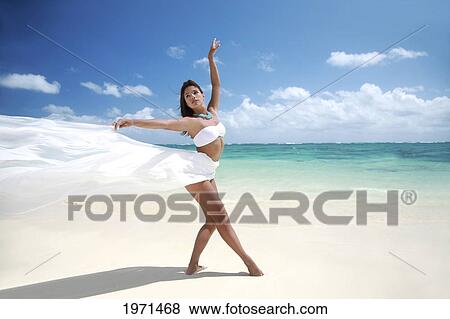 Stock Photo - Hawaii, Oahu, Lanikai Beach, Beautiful Female Ballet Dancer On Beach Wearing White Flowing Fabric.. Fotosearch
