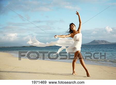Stock Photo - Hawaii, Oahu, Lanikai Beach, Beautiful Female Ballet Dancer On Beach Wearing White Flowing Fabric.. Fotosearch
