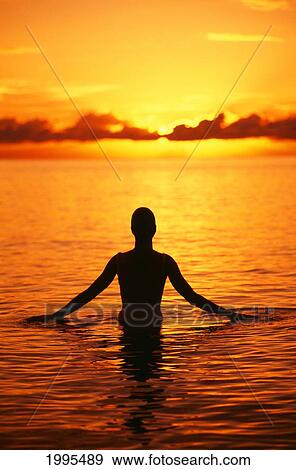 Stock Photo - Hawaii, Oahu, Lanikai Beach, Silhouette Of Woman Wading In The Ocean At Sunrise. Fotosearch