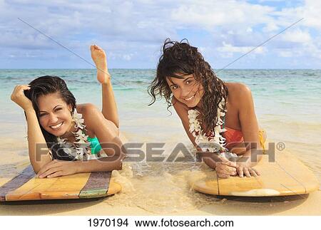 Picture - Hawaii, Oahu, Lanikai Beach, Two Girls Lounging On Surfboards. Fotosearch