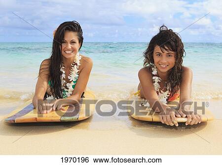Hawaii, Oahu, Lanikai Beach, Two Girls Lounging On Surfboards View Large Photo Image Stock Photograph - Hawaii, Oahu, Lanikai Beach, Two Girls Lounging On Surfboards. Fotosearch