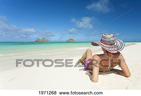 Stock Photo - Hawaii, Oahu, Lanikai Beach, Woman Relaxing Along Sandy Shore.. Fotosearch