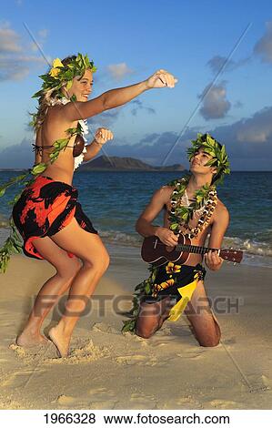 Hawaii, Oahu, Lanikai Beach, Young Couple Dancing Hula On Beach, Sunrise Light. View Large Photo Image Stock Photo - Hawaii, Oahu, Lanikai Beach, Young Couple Dancing Hula On Beach, Sunrise Light.. Fotosearch