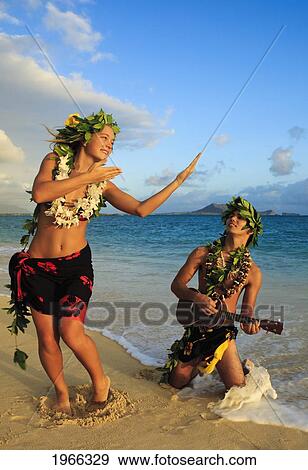 Hawaii, Oahu, Lanikai Beach, Young Couple Dancing Hula On Beach, Sunrise Light. View Large Photo Image Stock Photo - Hawaii, Oahu, Lanikai Beach, Young Couple Dancing Hula On Beach, Sunrise Light.. Fotosearch