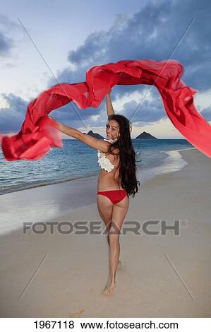 Hawaii, Oahu, Lanikai Beach, Young Woman Walking Down Beach With Red Scarf. View Large Photo Image Stock Photo - Hawaii, Oahu, Lanikai Beach, Young Woman Walking Down Beach With Red Scarf.. Fotosearch