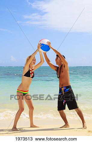Hawaii, Oahu, Lanikai Beautiful Couple On The Beach Playing Together. View Large Photo Image Stock Image - Hawaii, Oahu, Lanikai Beautiful Couple On The Beach Playing Together.. Fotosearch