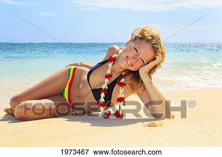Hawaii, Oahu, Lanikai, Beautiful Girl Enjoying A Day Out While Wearing A Lei. View Large Photo Image Stock Photo - Hawaii, Oahu, Lanikai, Beautiful Girl Enjoying A Day Out While Wearing A Lei.. Fotosearch