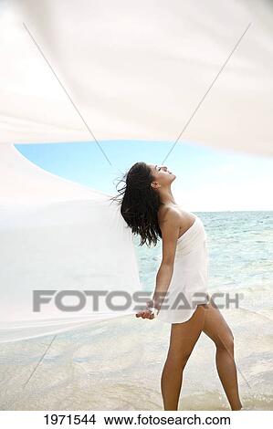 Hawaii, Oahu, Lanikai, Beautiful Young Woman On Beach With White Fabric Blowing In The Wind. View Large Photo Image Picture - Hawaii, Oahu, Lanikai, Beautiful Young Woman On Beach With White Fabric Blowing In The Wind.. Fotosearch