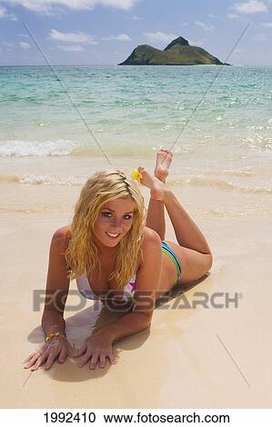 Hawaii, Oahu, Lanikai, Beautiful Young Woman Laying In The Sand On A Tropical Beach. View Large Photo Image Stock Image - Hawaii, Oahu, Lanikai, Beautiful Young Woman Laying In The Sand On A Tropical Beach.. Fotosearch