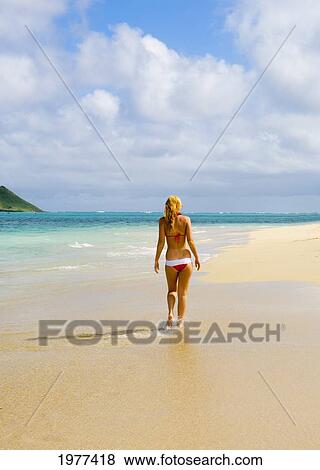 Stock Photo - Hawaii, Oahu, Lanikai, Bikini-Clad Girl Walking On Beach, View From Behind.. Fotosearch