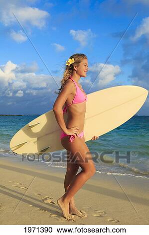 Stock Image - Hawaii, Oahu, Lanikai, Blond Surfer Girl With Surfboard Along Beach.. Fotosearch
