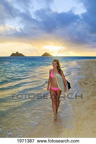 Stock Photo - Hawaii, Oahu, Lanikai, Blond Surfer Girl With Surfboard Along Beach.. Fotosearch