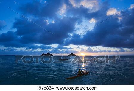 Picture - Hawaii, Oahu, Lanikai, Canoe Paddler And Stand Up Paddler Early Morning Sunrise On The Beach.. Fotosearch