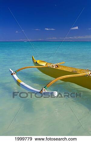 Stock Photo - Hawaii, Oahu, Lanikai, Close-Up Yellow Canoe In Turquoise Ocean, Molokai Visible Background D1604. Fotosearch