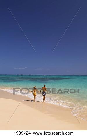 Hawaii, Oahu, Lanikai, Couple Run On The Beach Holding Hands. View Large Photo Image Picture - Hawaii, Oahu, Lanikai, Couple Run On The Beach Holding Hands.. Fotosearch