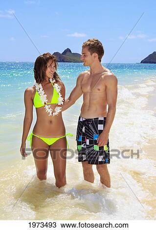 Hawaii, Oahu, Lanikai, Couple Standing In The Ocean. View Large Photo Image Stock Image - Hawaii, Oahu, Lanikai, Couple Standing In The Ocean.. Fotosearch