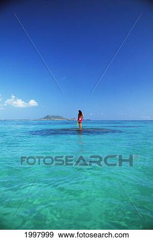 Hawaii, Oahu, Lanikai, Distant. Woman Standing On Reef, Lei, Pareo. View Large Photo Image Stock Photo - Hawaii, Oahu, Lanikai, Distant. Woman Standing On Reef, Lei, Pareo.. Fotosearch