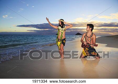 Picture - Hawaii, Oahu, Lanikai, Hula Dancer Couple Along Beach Shoreline At Sunrise.. Fotosearch