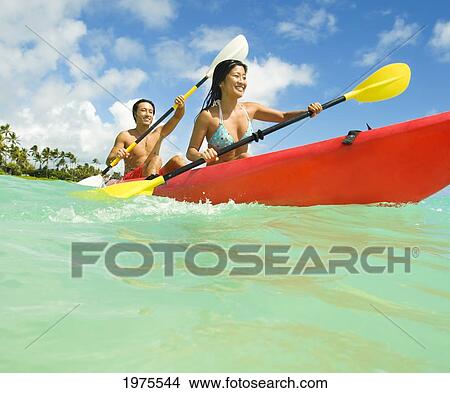 Picture - Hawaii, Oahu, Lanikai, Japanese Couple Kayaking In The Ocean.. Fotosearch