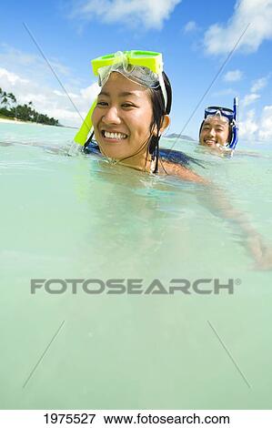 Hawaii, Oahu, Lanikai, Japanese Couple In The Ocean With Snorkel Gear. View Large Photo Image Stock Photo - Hawaii, Oahu, Lanikai, Japanese Couple In The Ocean With Snorkel Gear.. Fotosearch