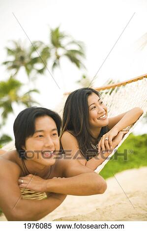 Stock Photography - Hawaii, Oahu, Lanikai, Japanese Couple In Hammock.. Fotosearch