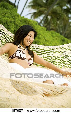 Stock Image - Hawaii, Oahu, Lanikai, Japanese Woman In Hammock.. Fotosearch