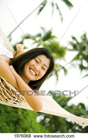 Stock Photo - Hawaii, Oahu, Lanikai, Japanese Woman In Hammock.. Fotosearch