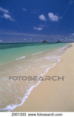 Stock Image - Hawaii, Oahu, Lanikai, Kailua Beach Shoreline With Ocean Mokulua Islands Distant Background Blue Sky. Fotosearch