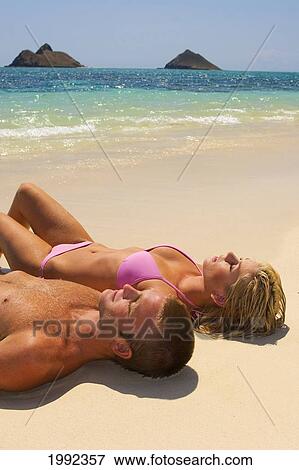 Hawaii, Oahu, Lanikai, Laying On The Sand Of A Tropical Beach. View Large Photo Image Stock Photo - Hawaii, Oahu, Lanikai, Laying On The Sand Of A Tropical Beach.. Fotosearch