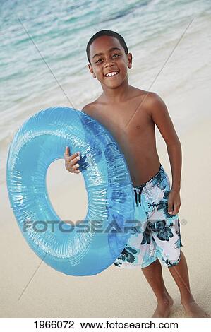 Hawaii, Oahu, Lanikai, /Nyoung Boy With Inflatable Toy Poses For Camera At Beach. View Large Photo Image Stock Image - Hawaii, Oahu, Lanikai, /Nyoung Boy With Inflatable Toy Poses For Camera At Beach.. Fotosearch